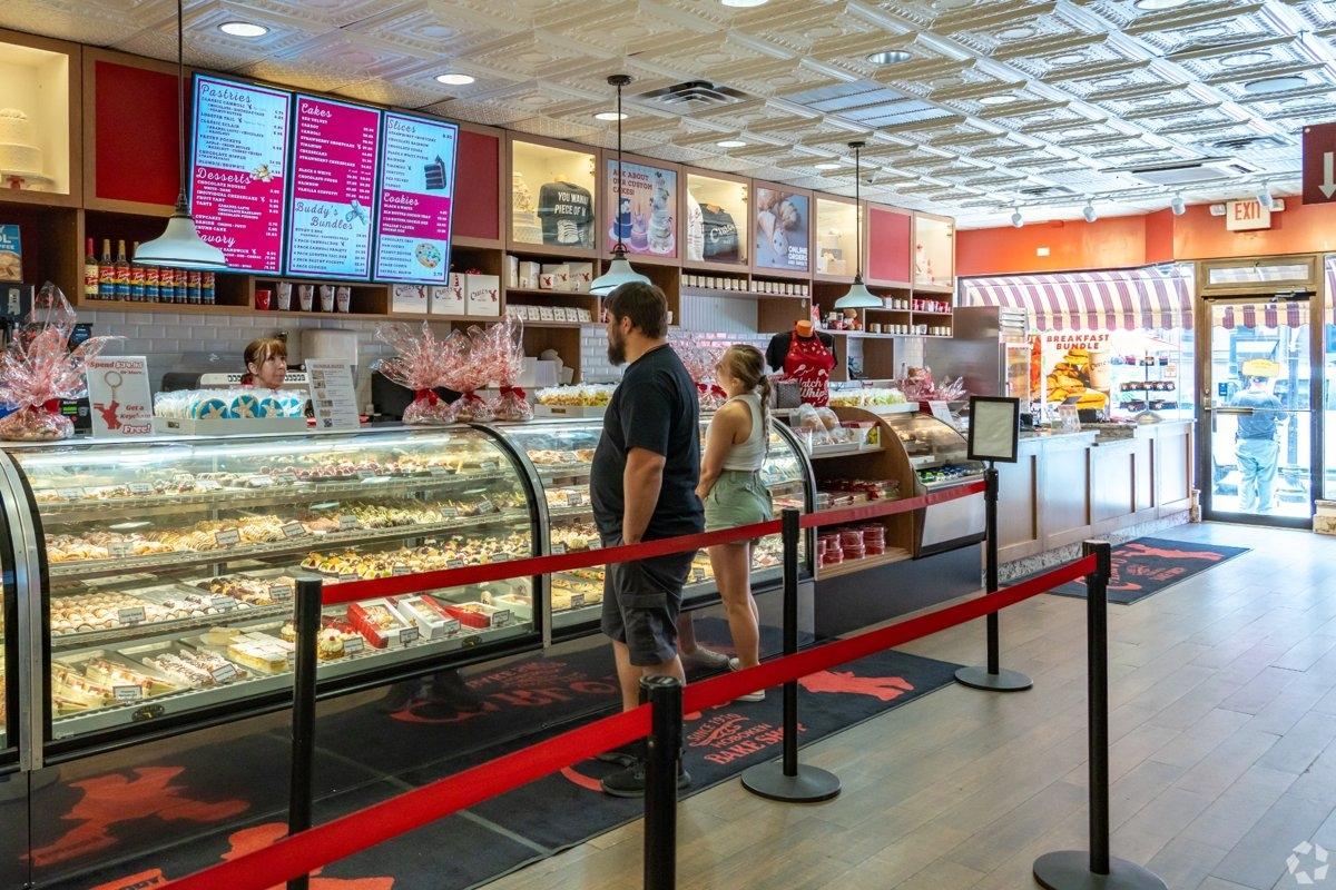 Interior of a Hoboken bakery with pastry display cases and customers in line – affordable local businesses in Southwest Hoboken.