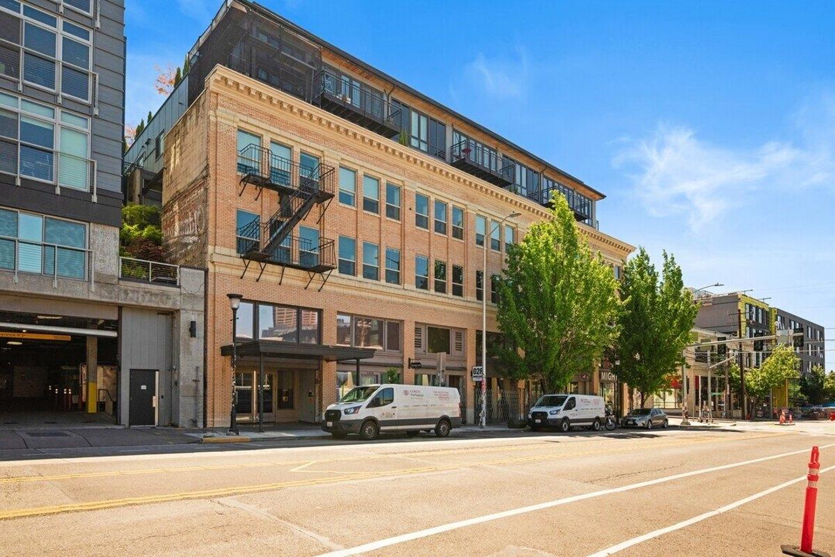 Renovated brick loft building in Seattle’s Capitol Hill neighborhood featuring large windows and urban-style fire escapes — ideal for trendy apartment conversions.