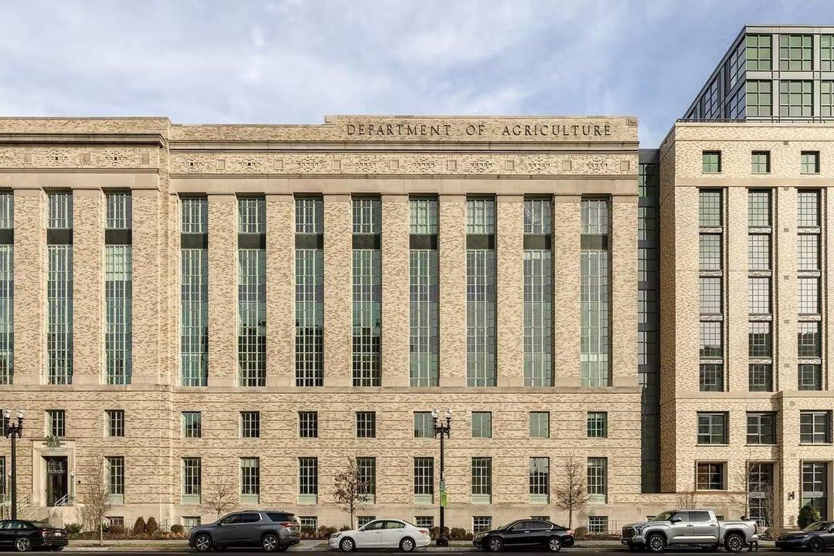 Historic government building with classical architecture and vertical glass windows — a prime example of adaptive reuse for residential conversions.