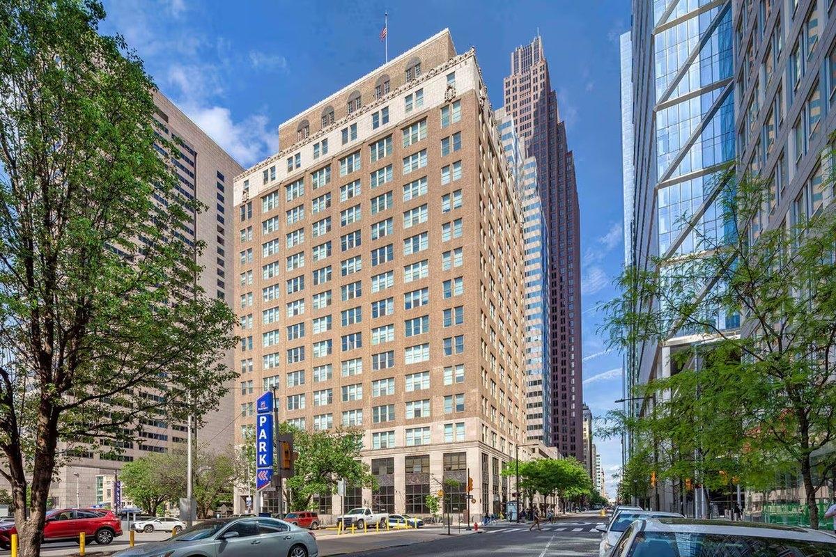 Downtown high-rise office building with uniform windows and ideal structural layout — perfect candidate for conversion into apartment housing.