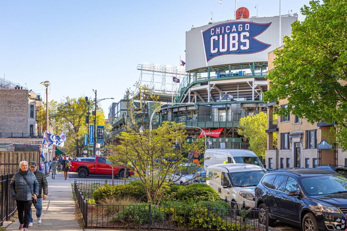 Street view of Wrigley Field and surrounding neighborhood, highlighting the energetic apartment living scene near the Chicago Cubs stadium.