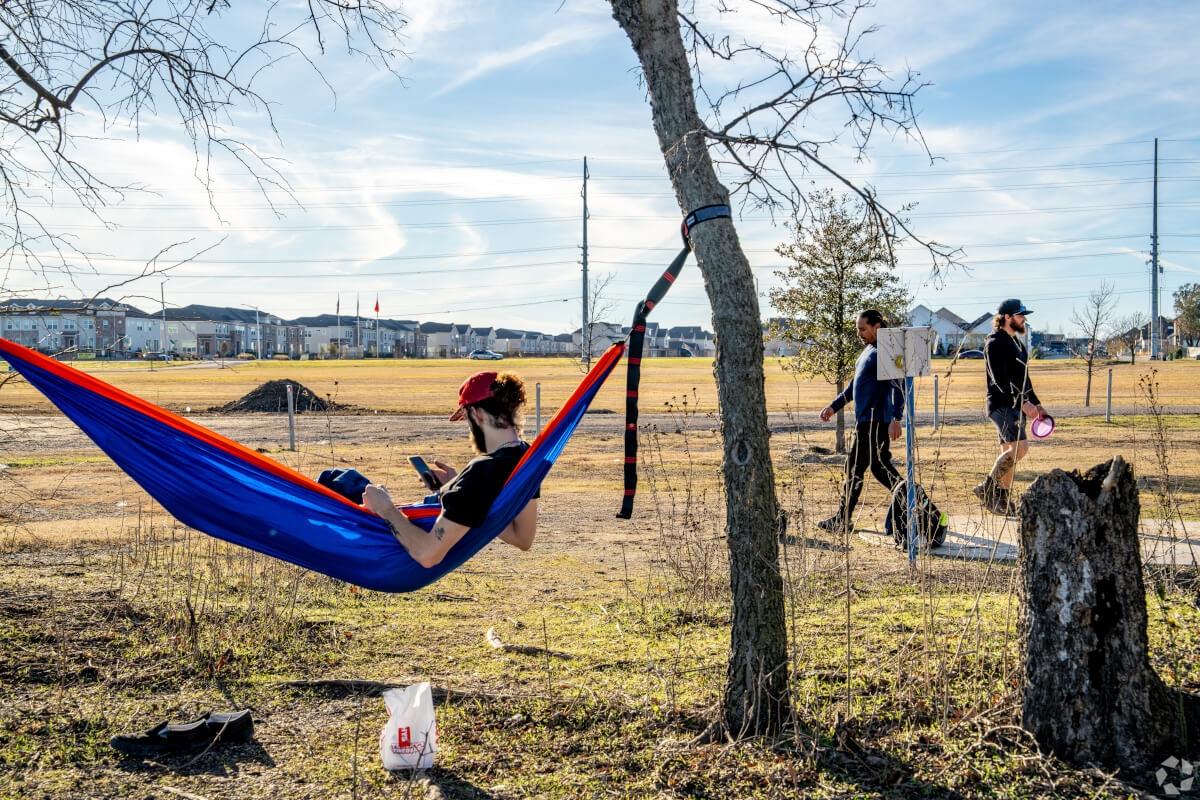 Pedestrians hang out in Denton, TX park