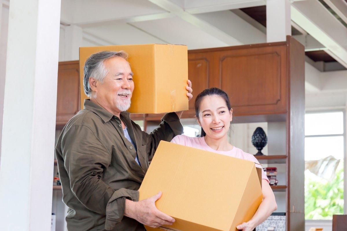 Parent helping young adult child move into new apartment.