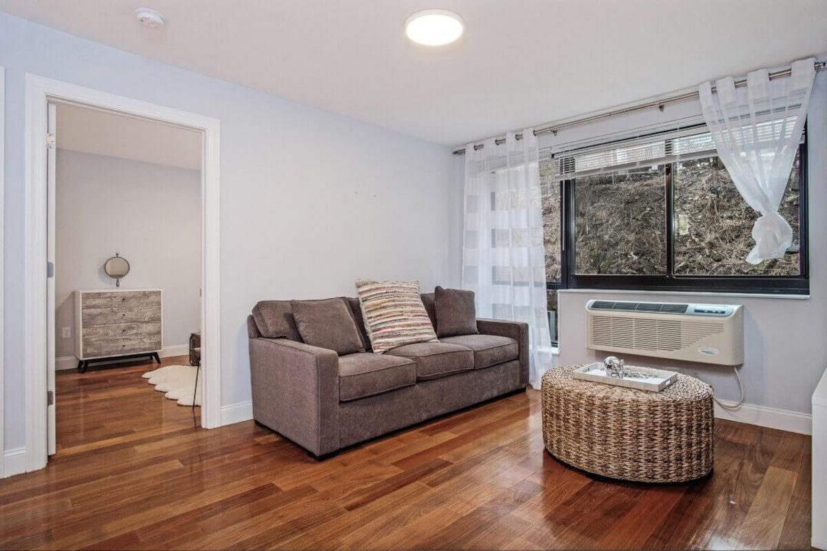 A model unit at The Post on Fort shows a couch in a living area.