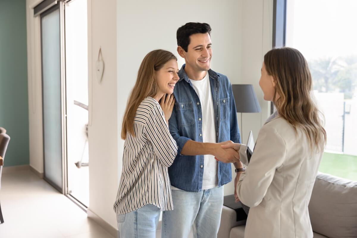 A young couple meets a landlord for the first time.