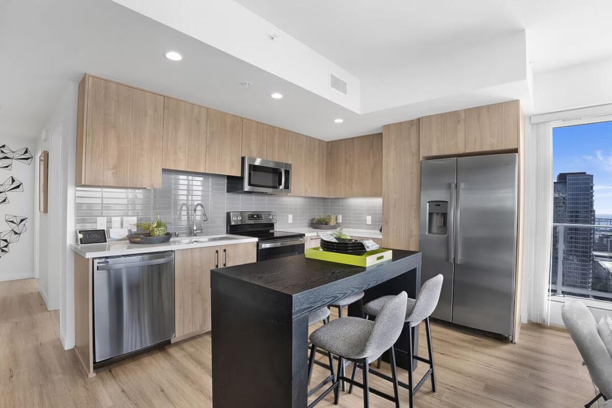 The kitchen at Pinnacle Broadway in San Diego, CA, has modern gray tile backsplash.