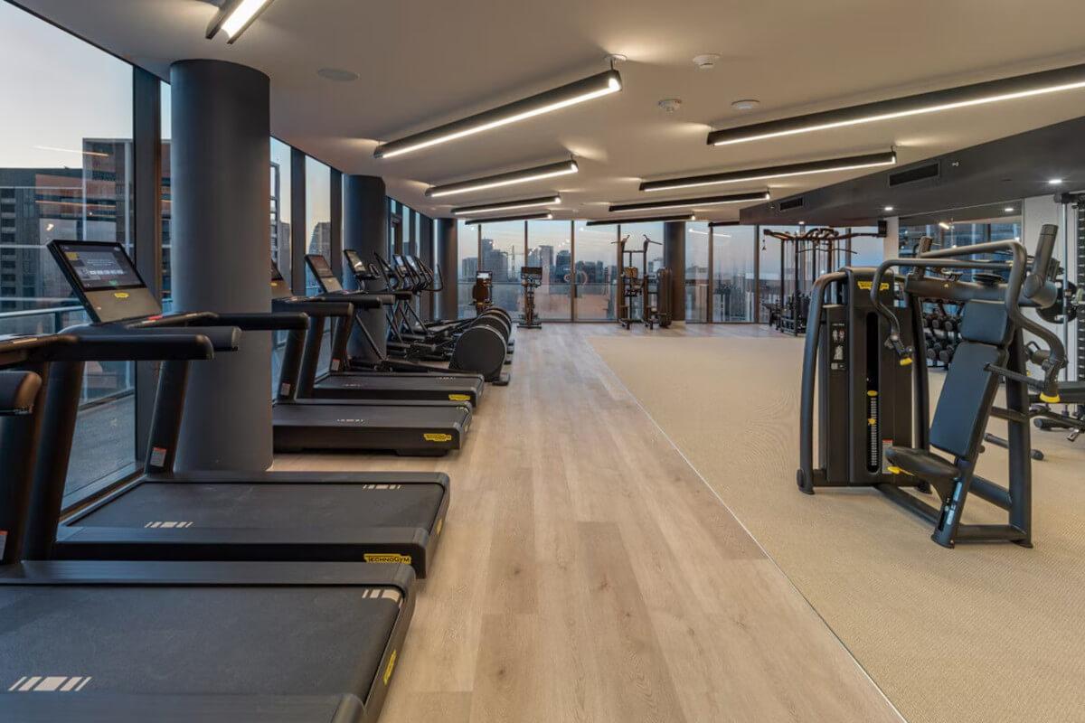 The community fitness center in Miami World Tower has a row of treadmills overlooking the city.