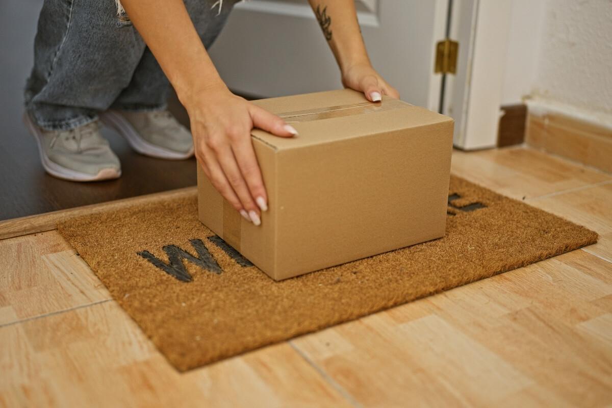 Tenant picks up package outside of their door. 