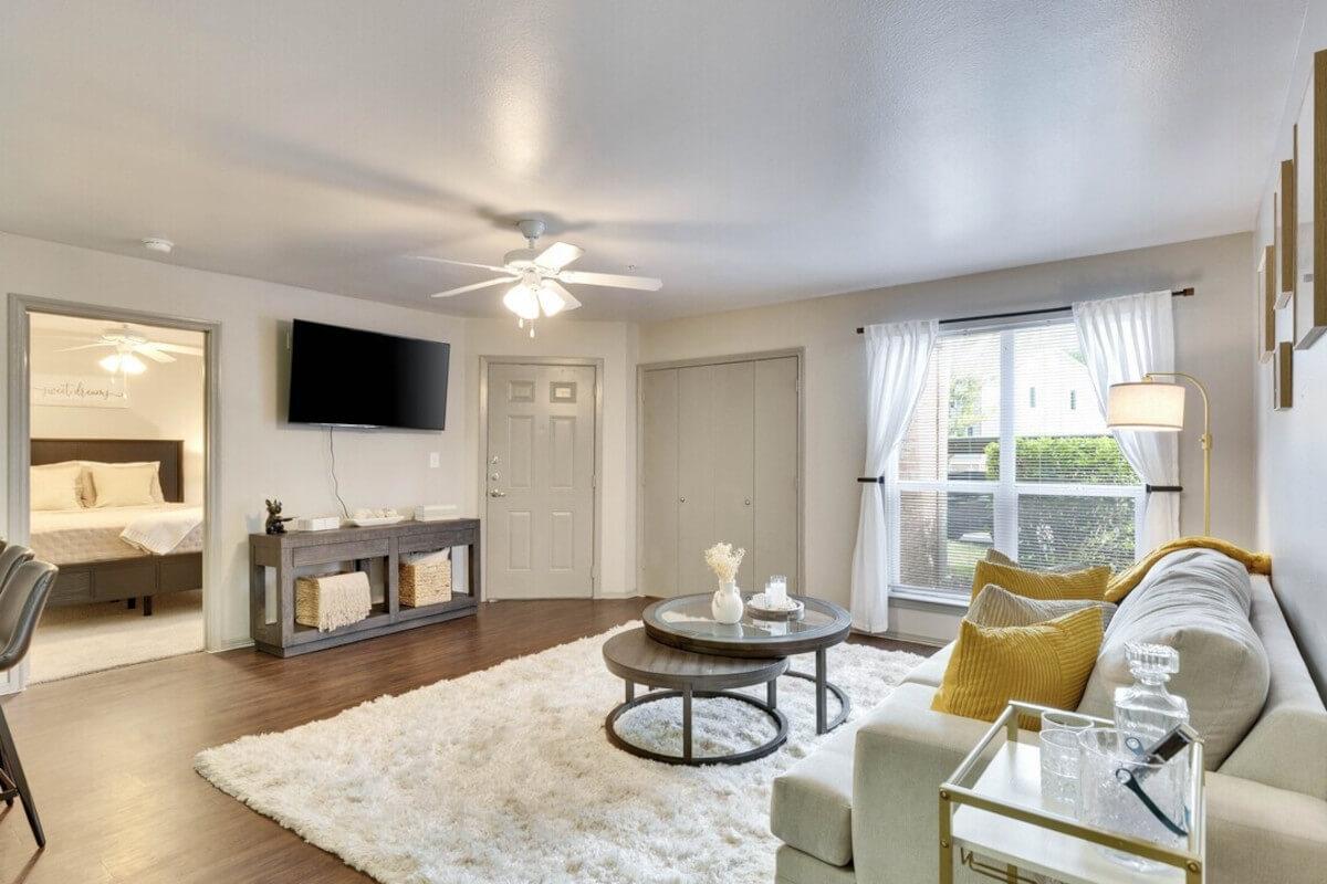 A fuzzy white rug in a living room in the Forest Park apartment community.