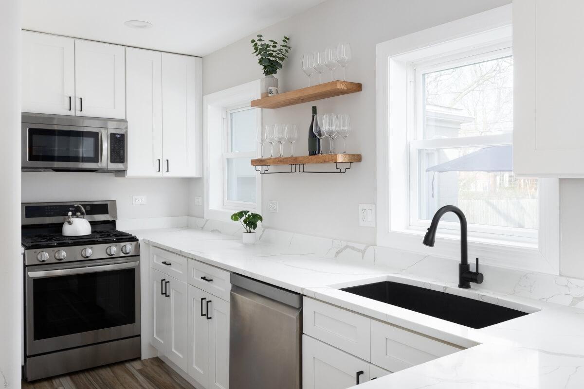 A modern kitchen in a luxury apartment has marble countertops.