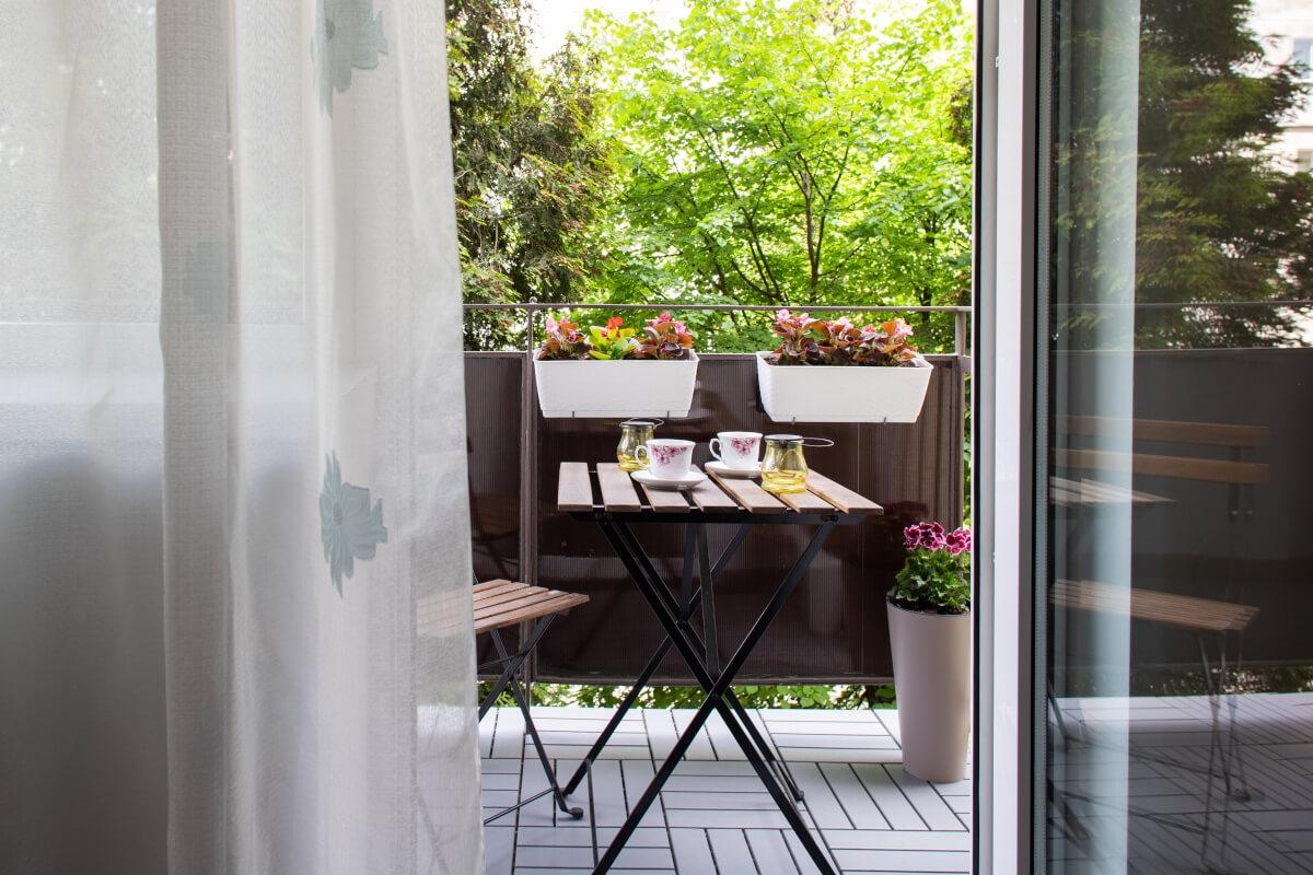 A view of a small bistro table on an apartment patio.