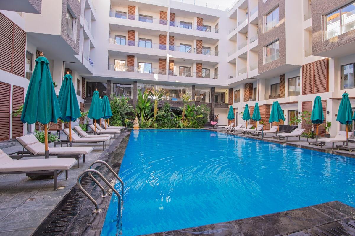 A resort-style pool at the center of a high-rise apartment community.
