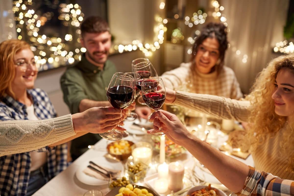 Friends toasting wine glasses at the dinner table