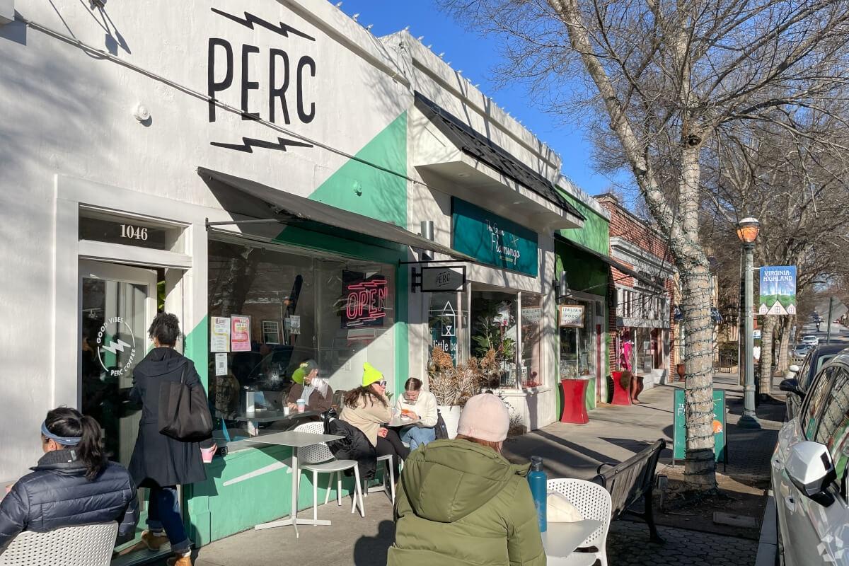 People sit outside a coffee shop in Virginia Highland’s retail center.