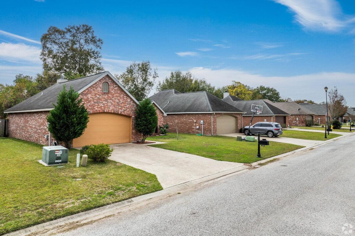 A car is parked in the driveway of a home on a residential street in Youngsville.