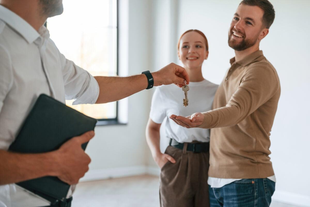 Leasing agent handing over apartment key.