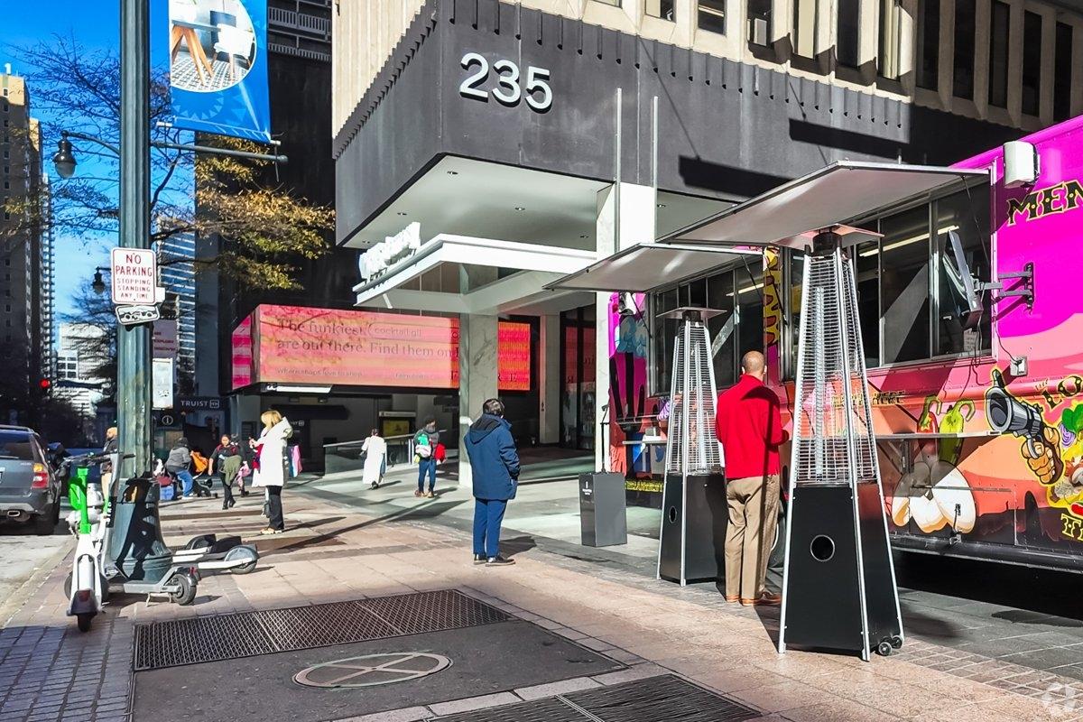 Residents walking on a busy street corner in Downtown Atlanta