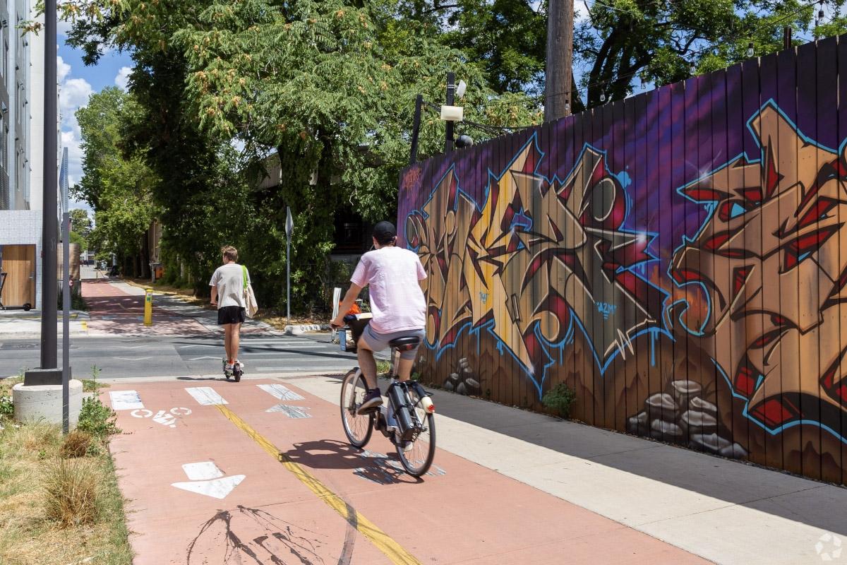 Two East Cesar Chavez residents on a bike trail in the heart of the neighborhood.