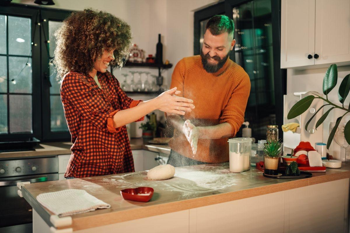 Couple bakes bread in their apartment.