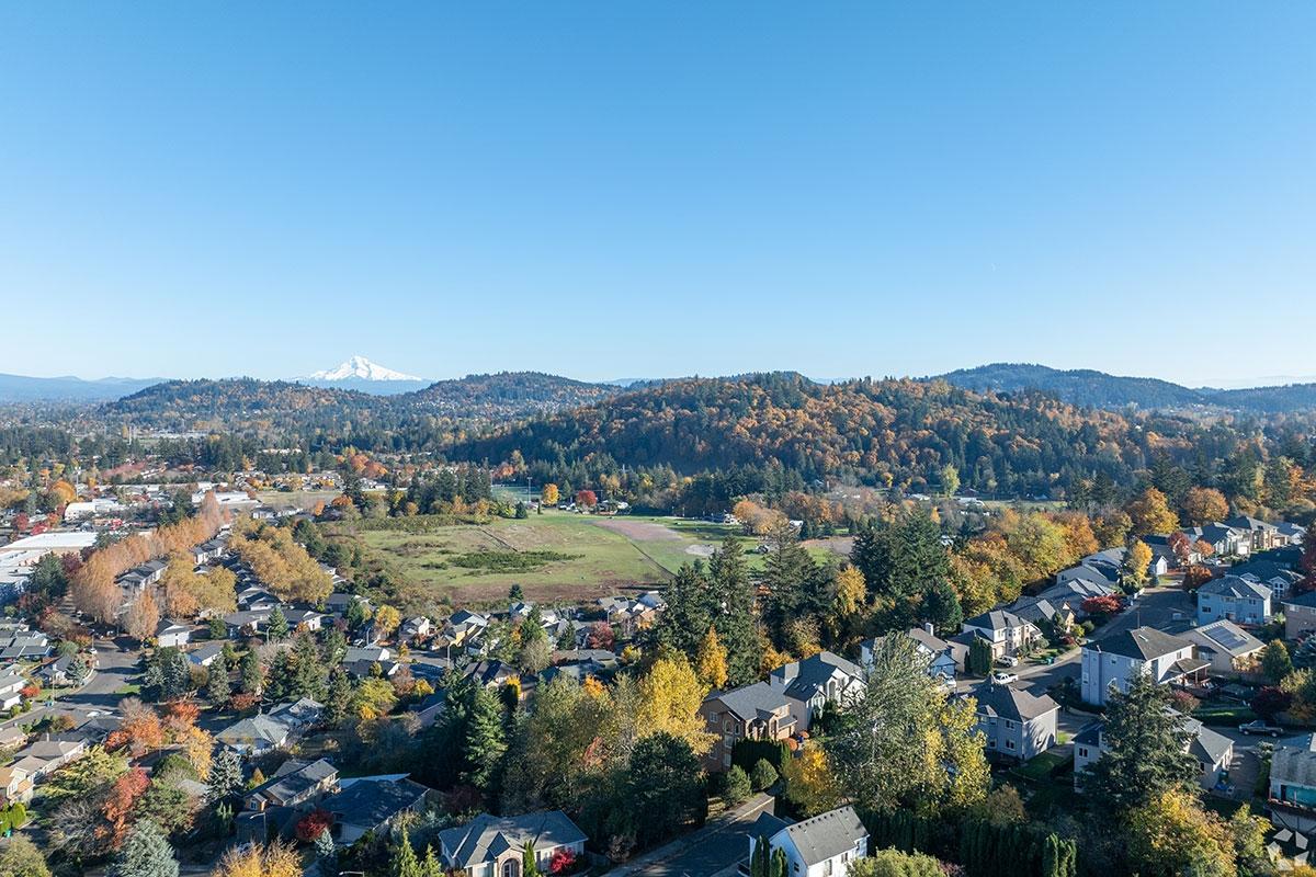 Centennial puts homes and apartments right next to the tree-covered hills of Powell Butte Nature Park.