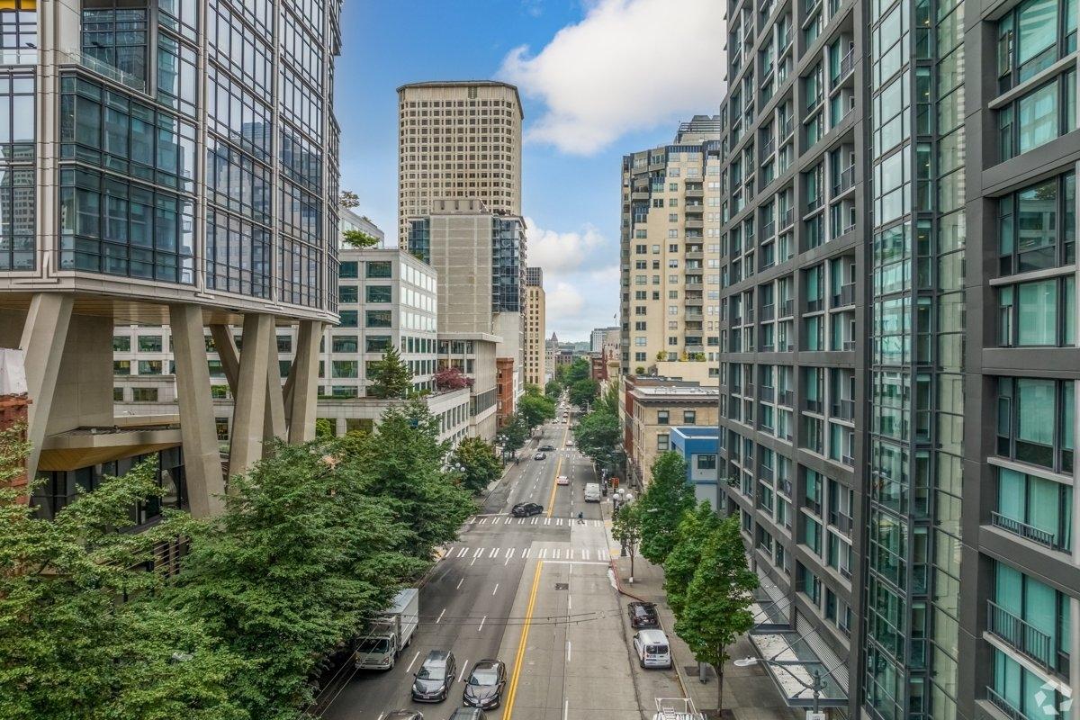 A view down a main street of tall high rises in downtown Seattle