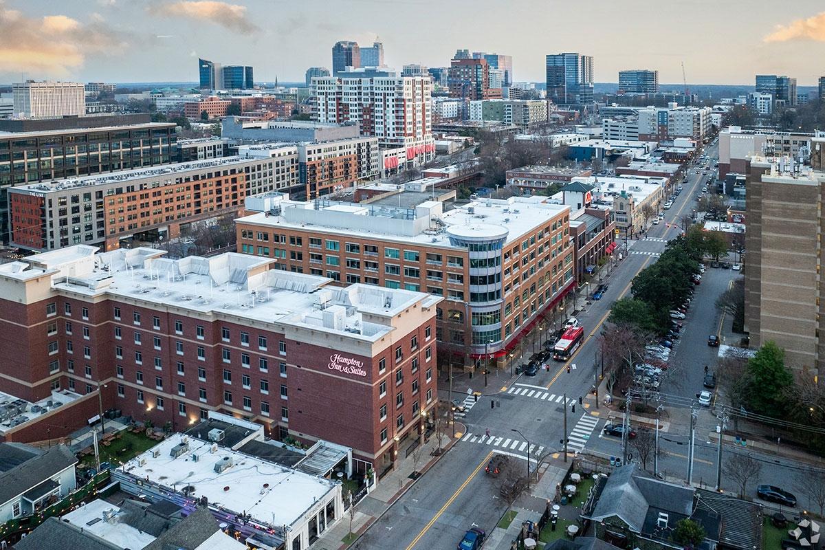 Mid-rise buildings, including apartments and hotels, line the street in Cameron Village.
