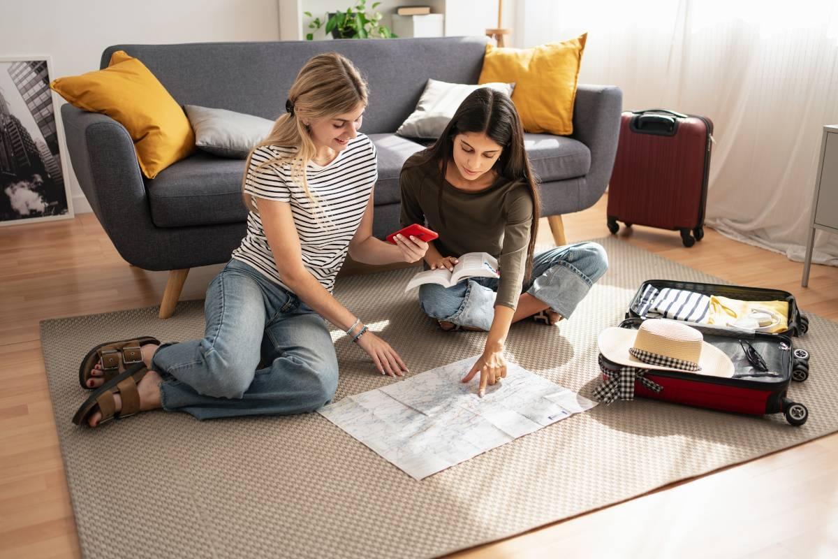 Two girls map out their move on their living room floor