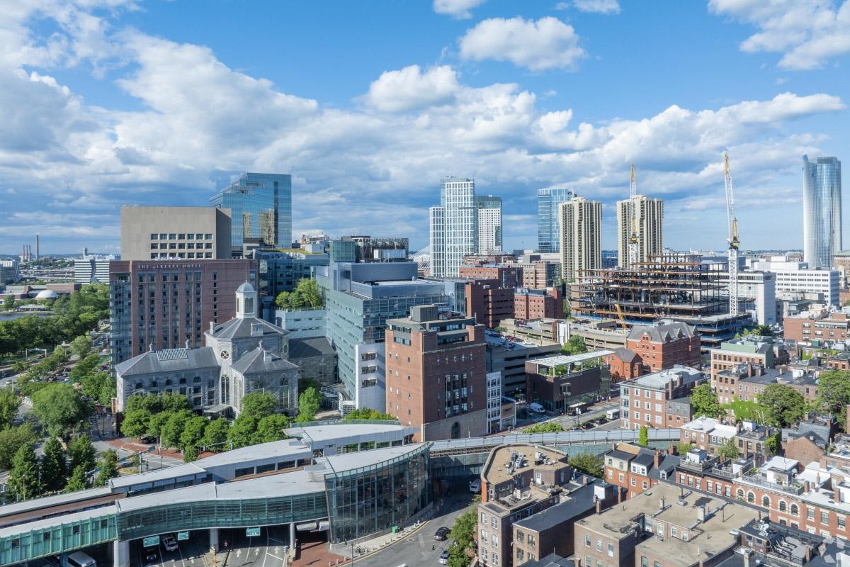 An aerial shot of high-rise apartment communities and office buildings in West End Boston.