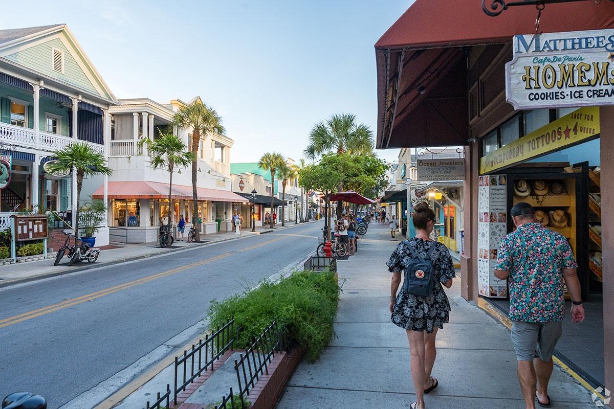 People walk along the cozy shops that line the main thoroughfare of Key West.
