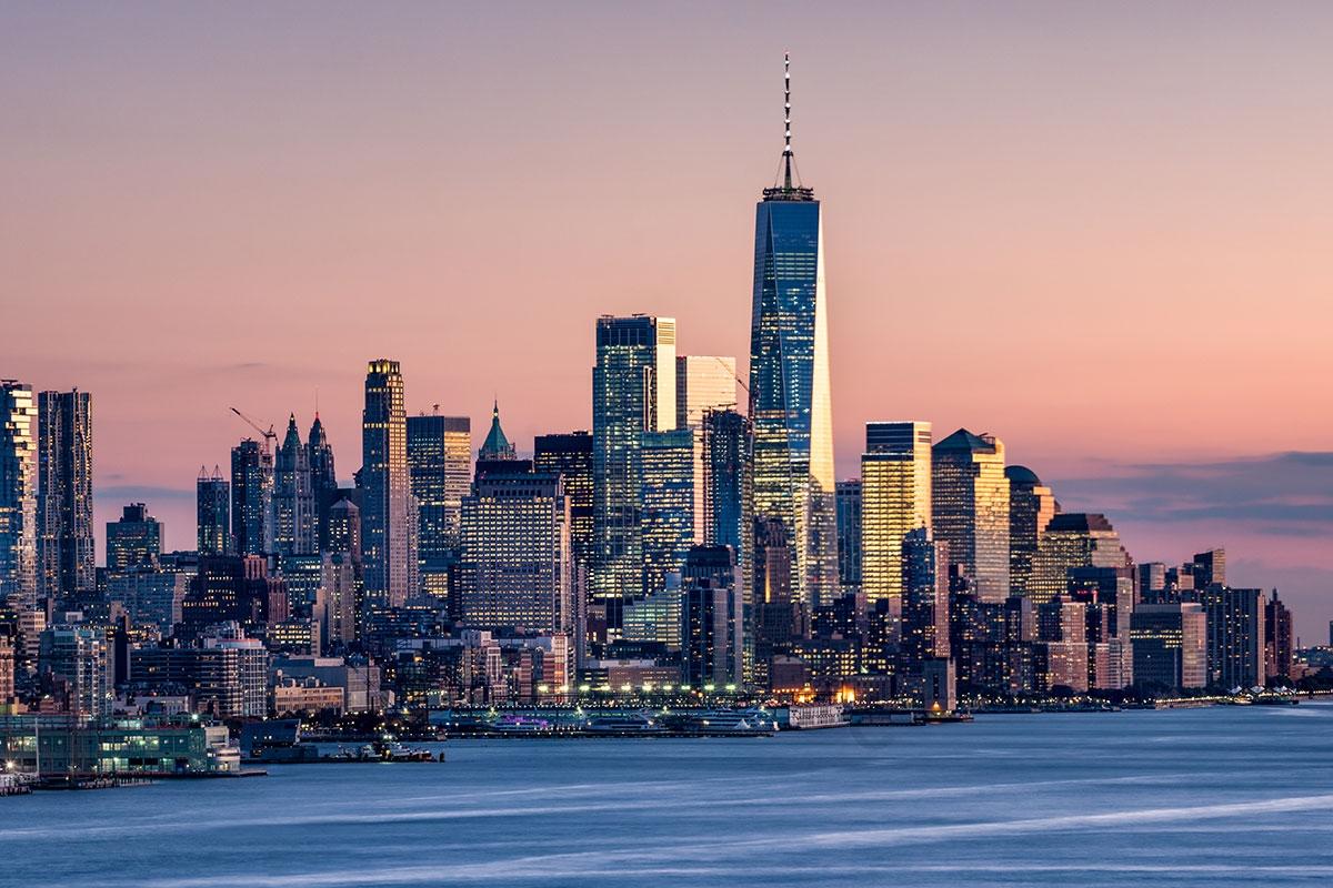The Financial District in New York lights up during the evening.