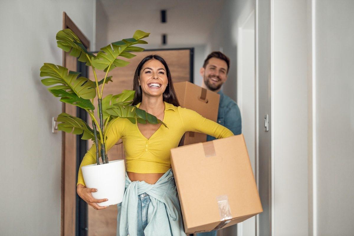 A happy couple moving into an apartment