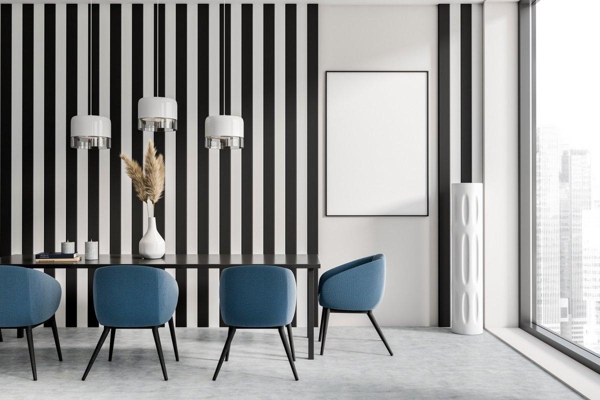 A dining room with black and white stripes from floor to ceiling