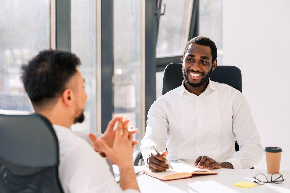 A tenant speaking with his landlord in the leasing office
