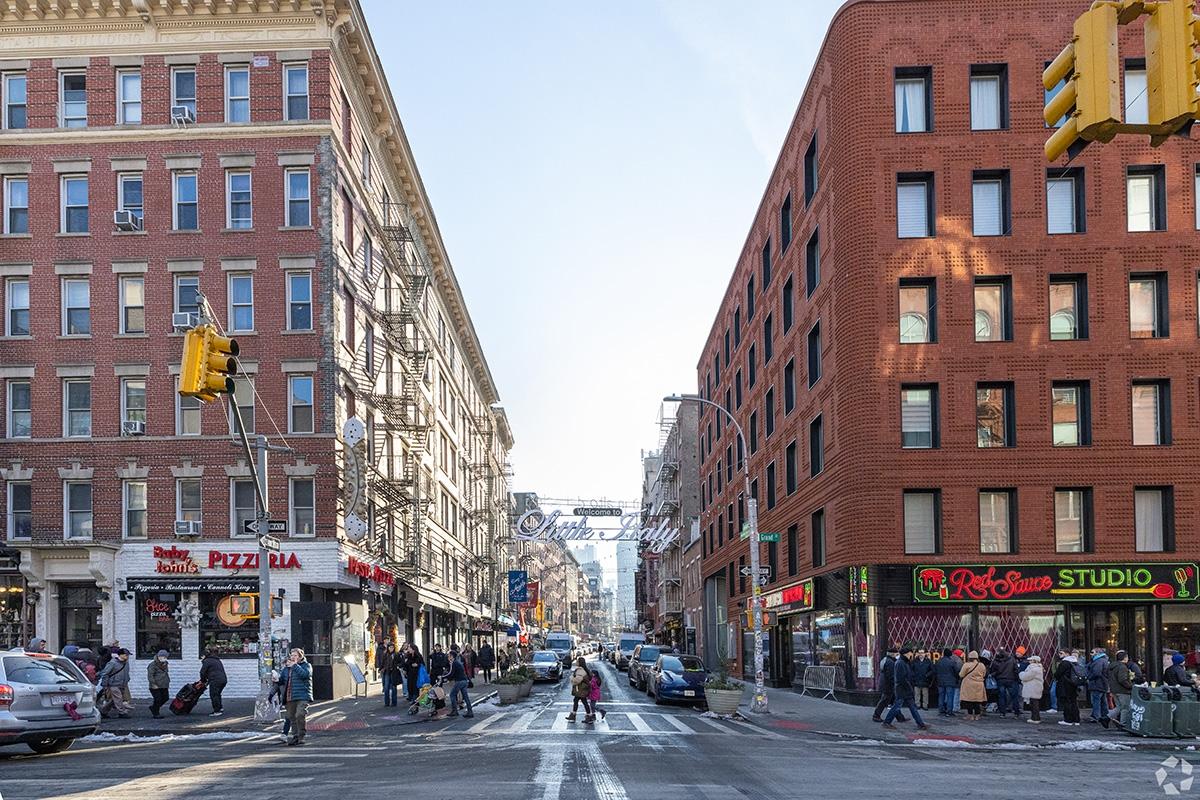 The Little Italy sign sits above the street.