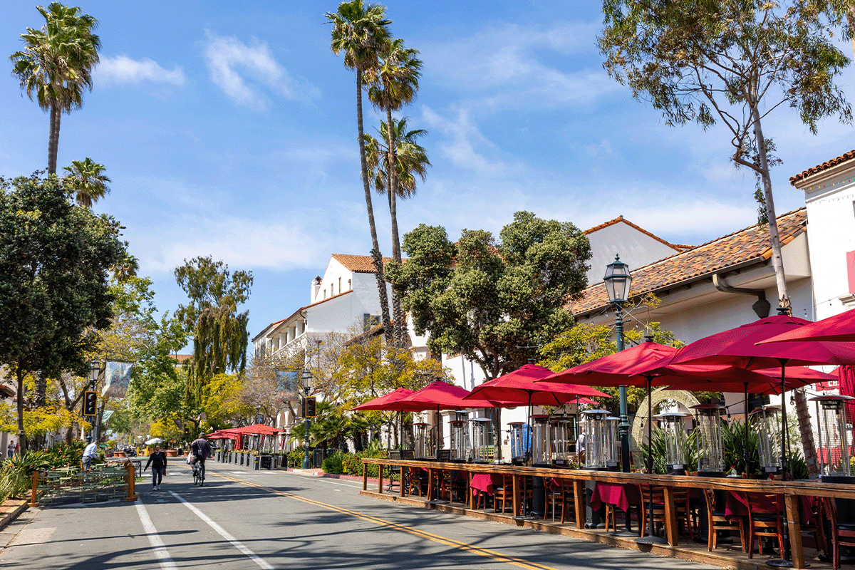 Santa Barbara street with outdoor seating and palm trees