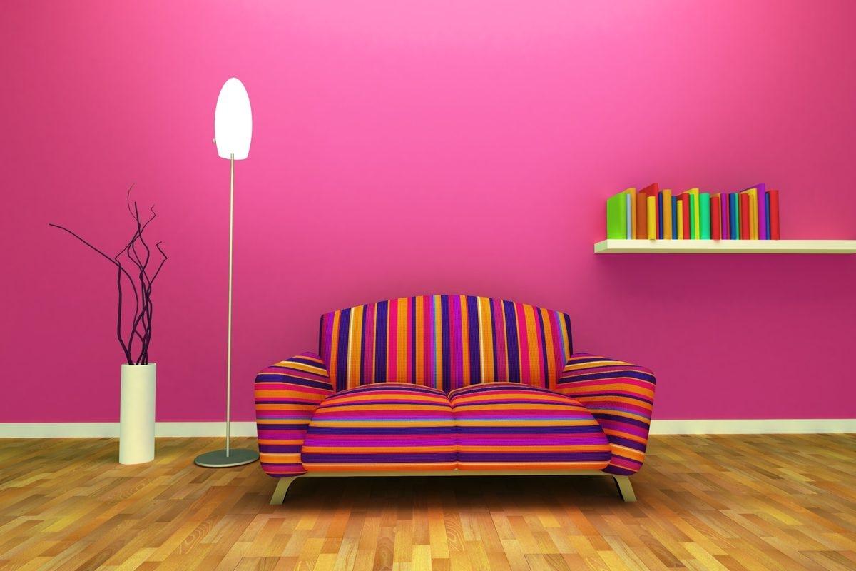 A uniquely-shaped sofa against a bright pink wall