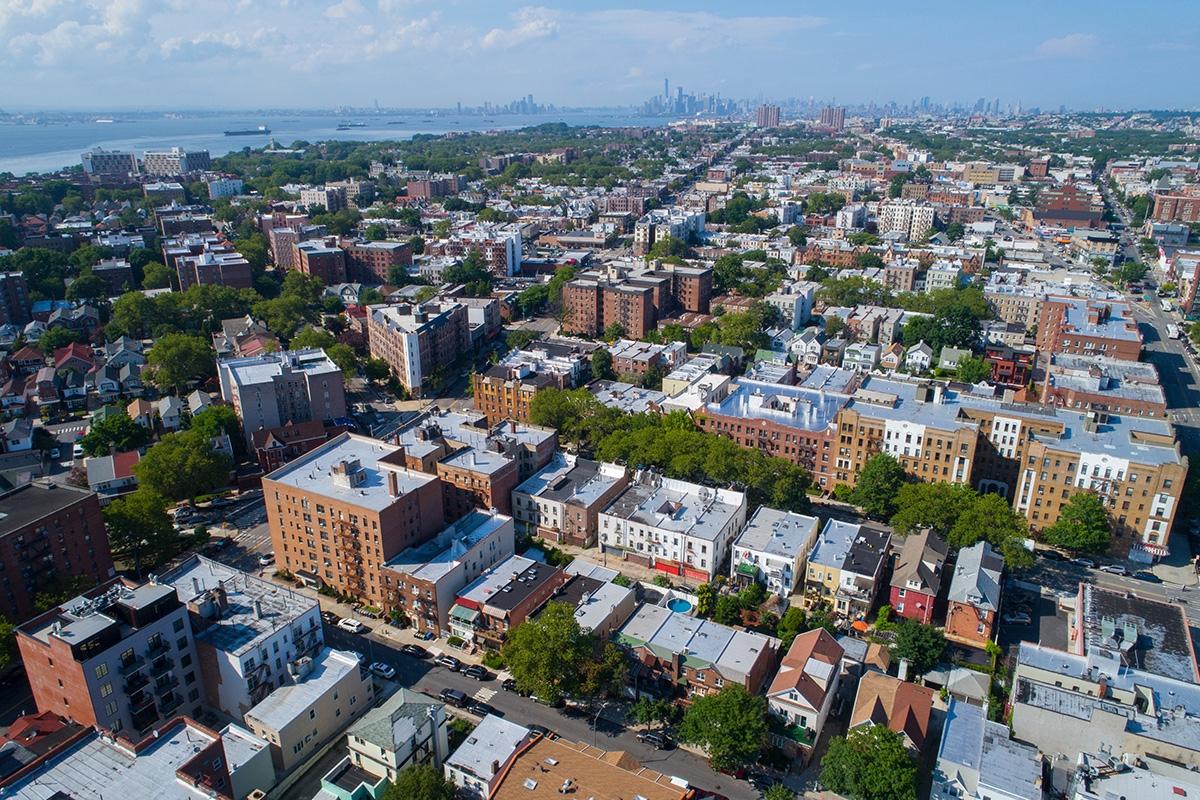 Manhattan rises in the distance over Brooklyn.