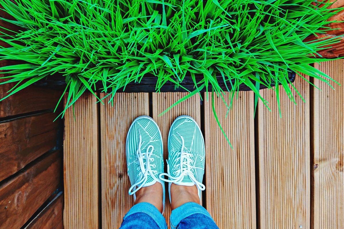 Brightly-colored tennis shoes on a wooden patio