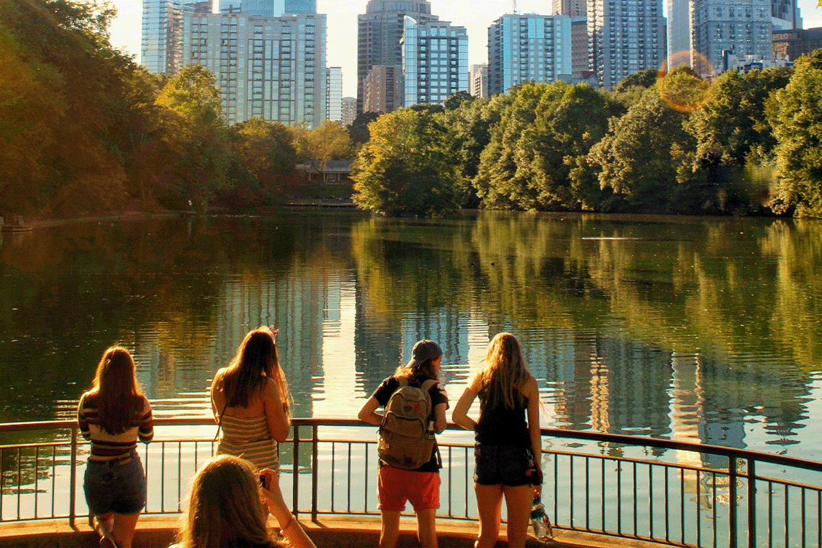 People Overlooking Pond at Piedmont Park