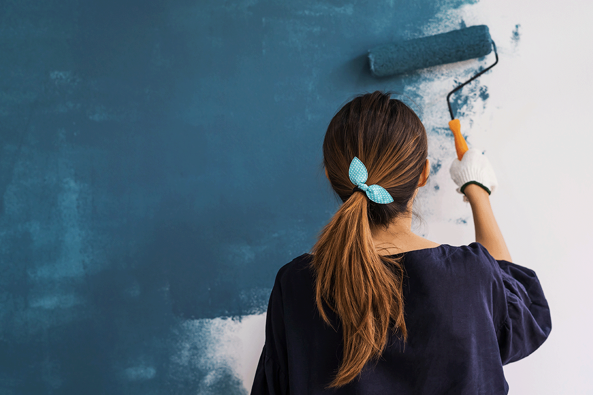 Woman painting wall DIY