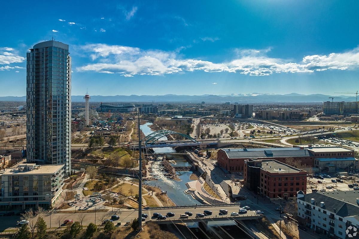 The South Platte River runs through Downtown Denver, lined with high-rises.