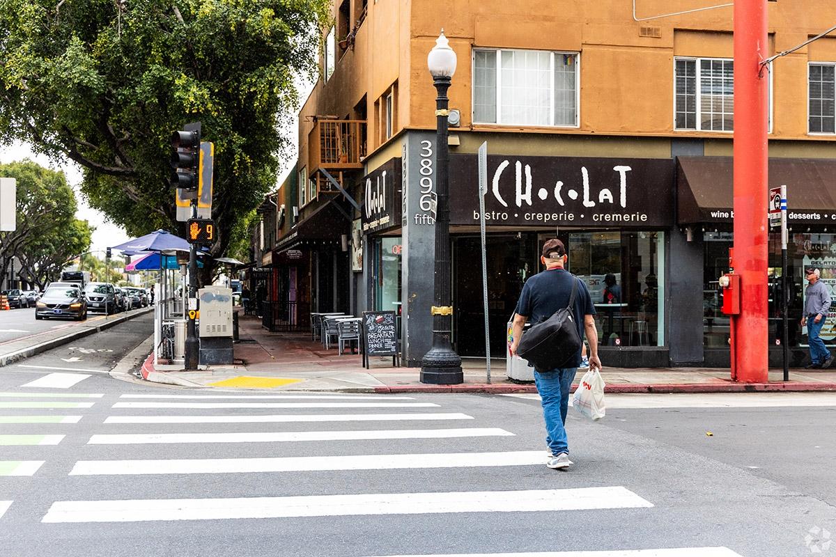 A man walks on the main street in Hillcrest.