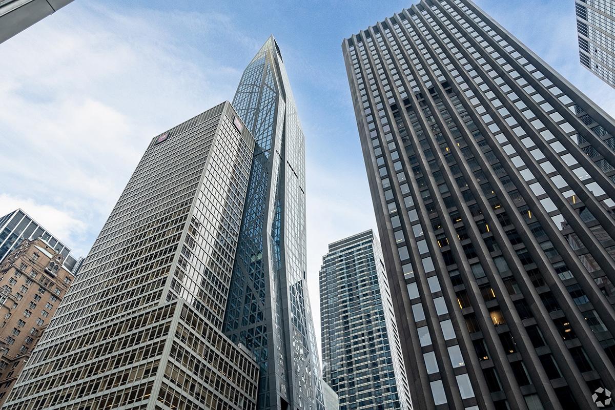 A high-rise apartment building towers over neighboring buildings in New York.
