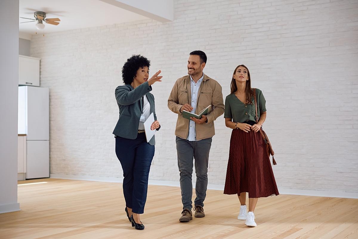 A broker showing an apartment to a couple in NYC.