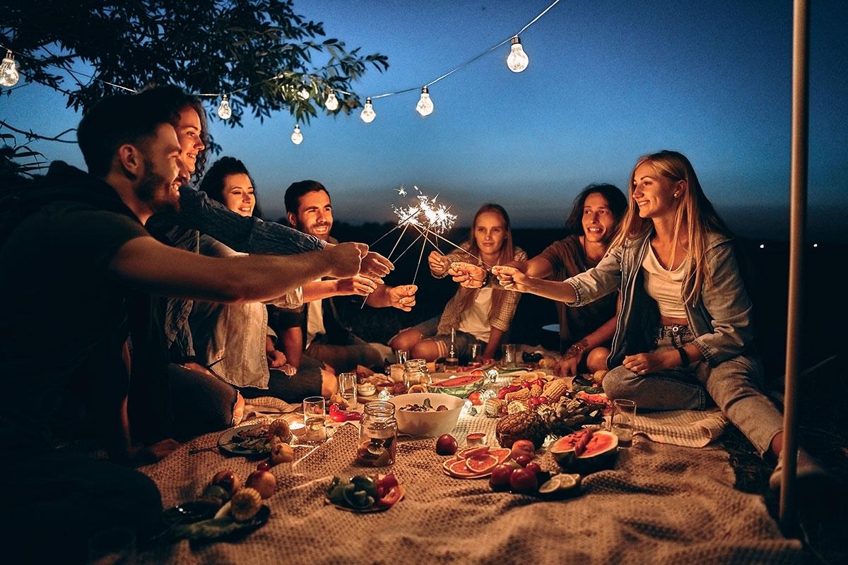 Group of friends having a party outside during the summer.