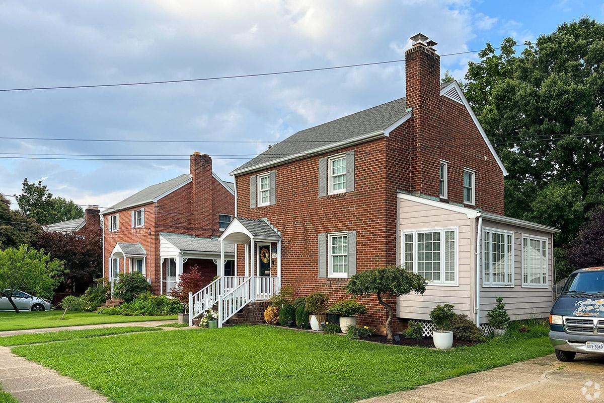 Brick homes sit behind green lawns in Penrose.