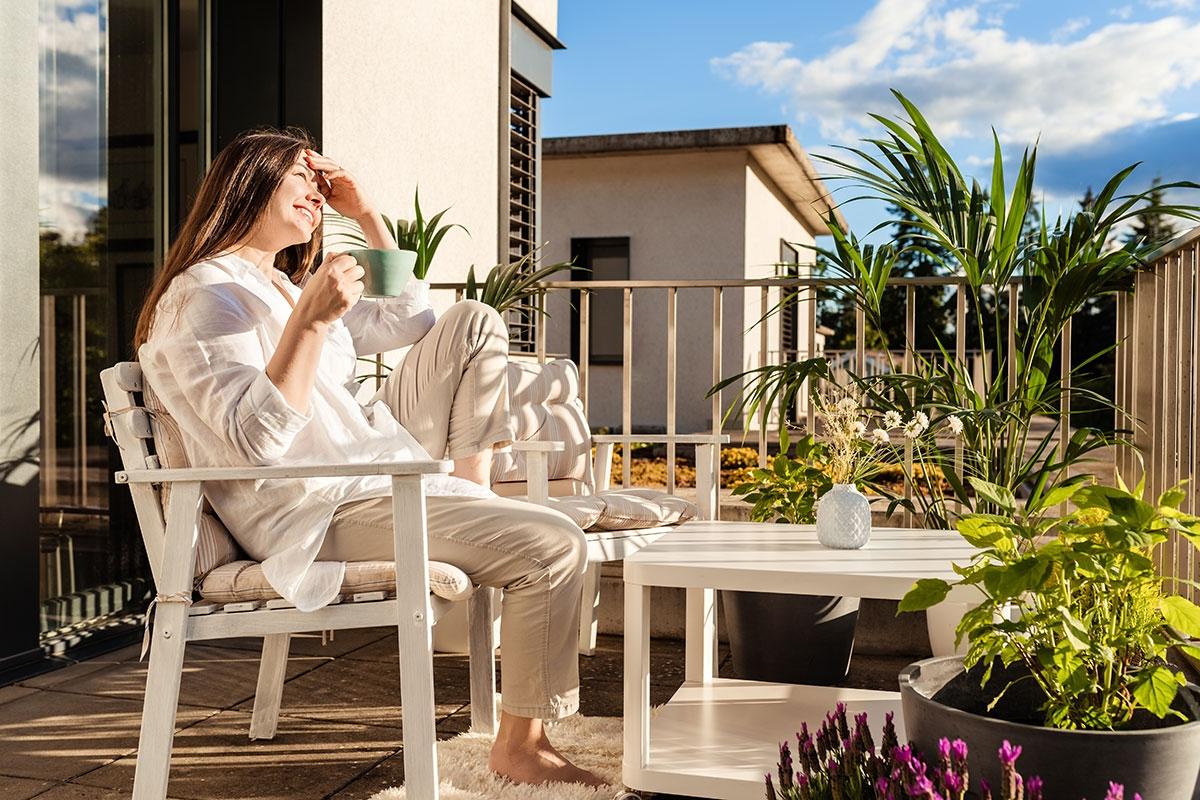 Renter sitting on their balcony after making upgrades.