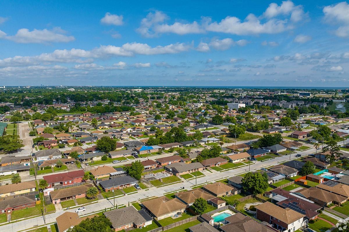 Homes sit in a grid street layout in Read Boulevard East with a few trees in yards.