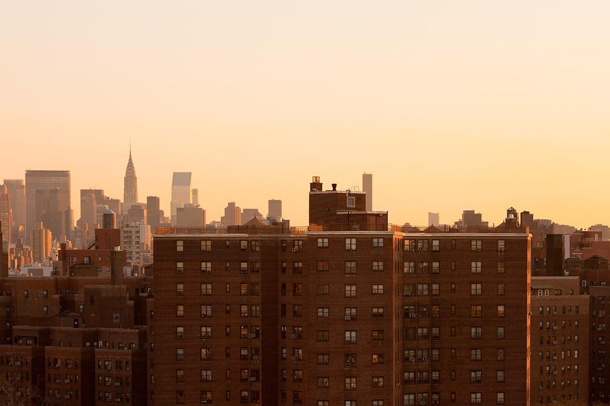 Skyline of housing projects in New York against the setting sun.