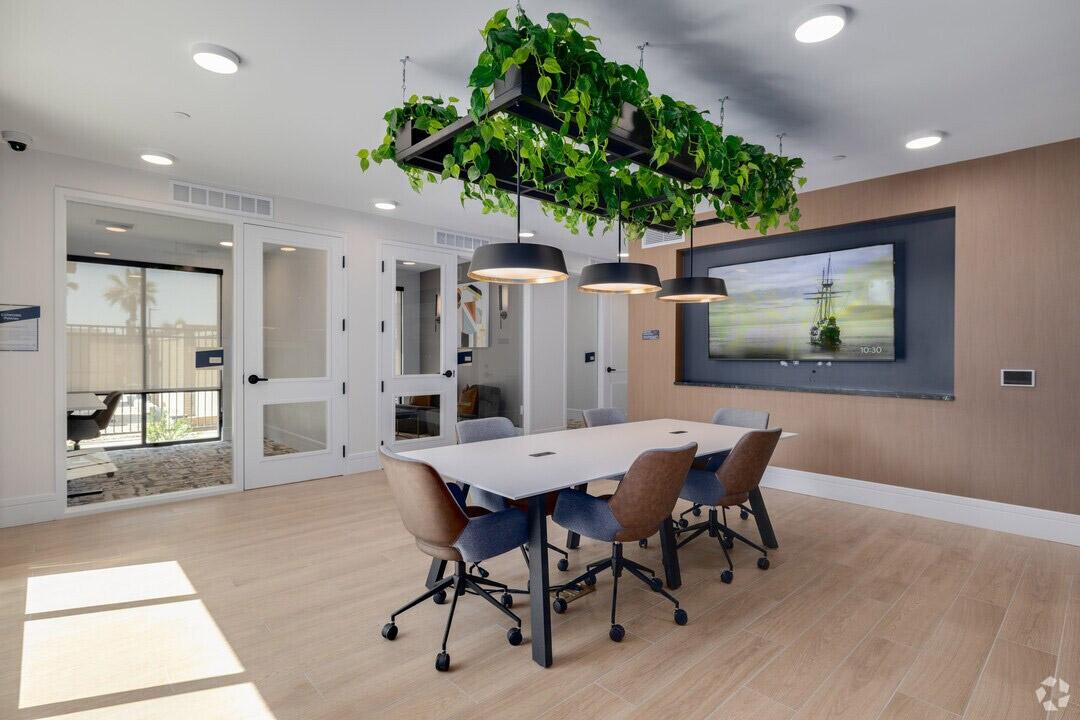 A modern coworking space in a luxury apartment community has private meetings rooms and a large conference room.